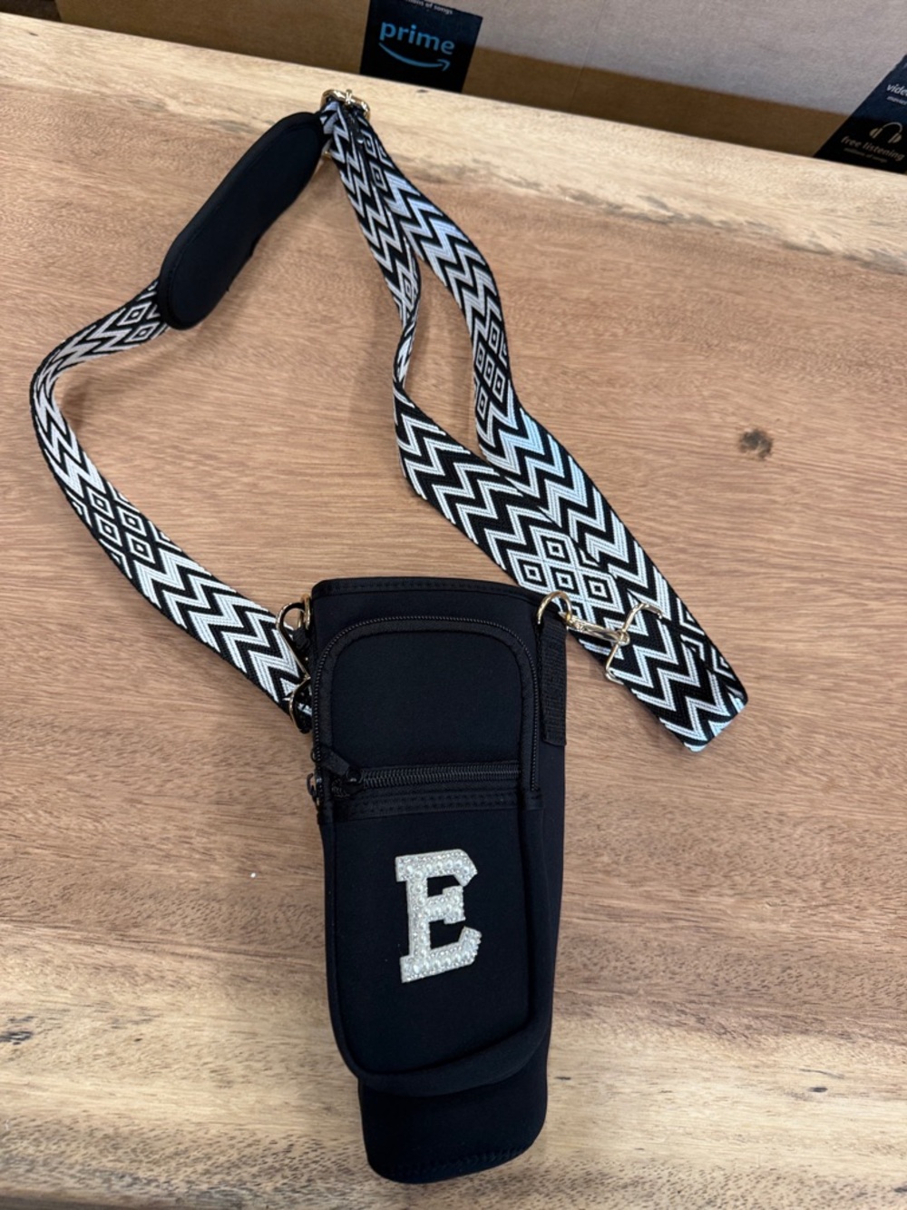 Black Crossbody Bottle Holder with Zigzag Strap and Glitter 'E'
